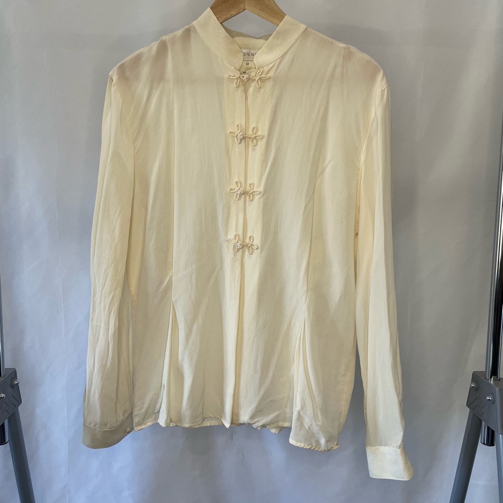 Cream Jones New York blouse. Bow wrap buttons for a delicate & feminine touch.